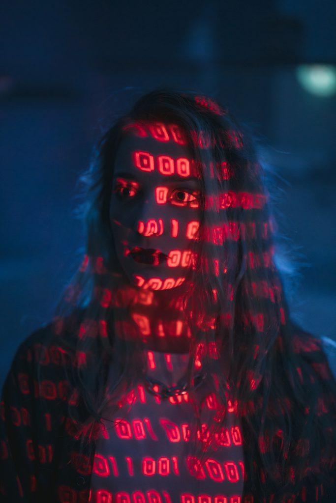 A woman with red lights on her face.